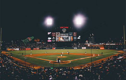 View from the crowd of a baseball game at night